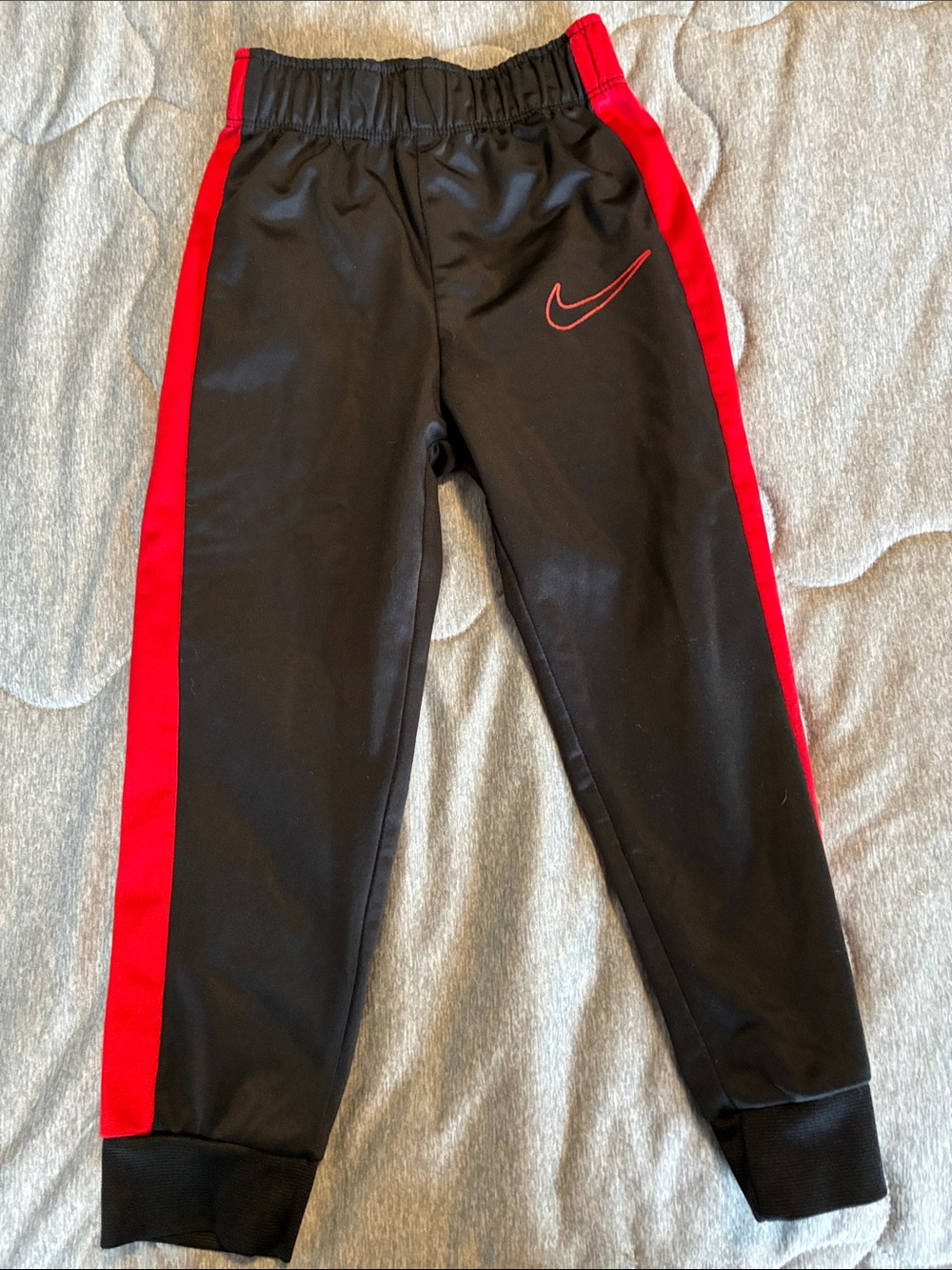 Nike Kids Black Joggers with Red Side Stripes
